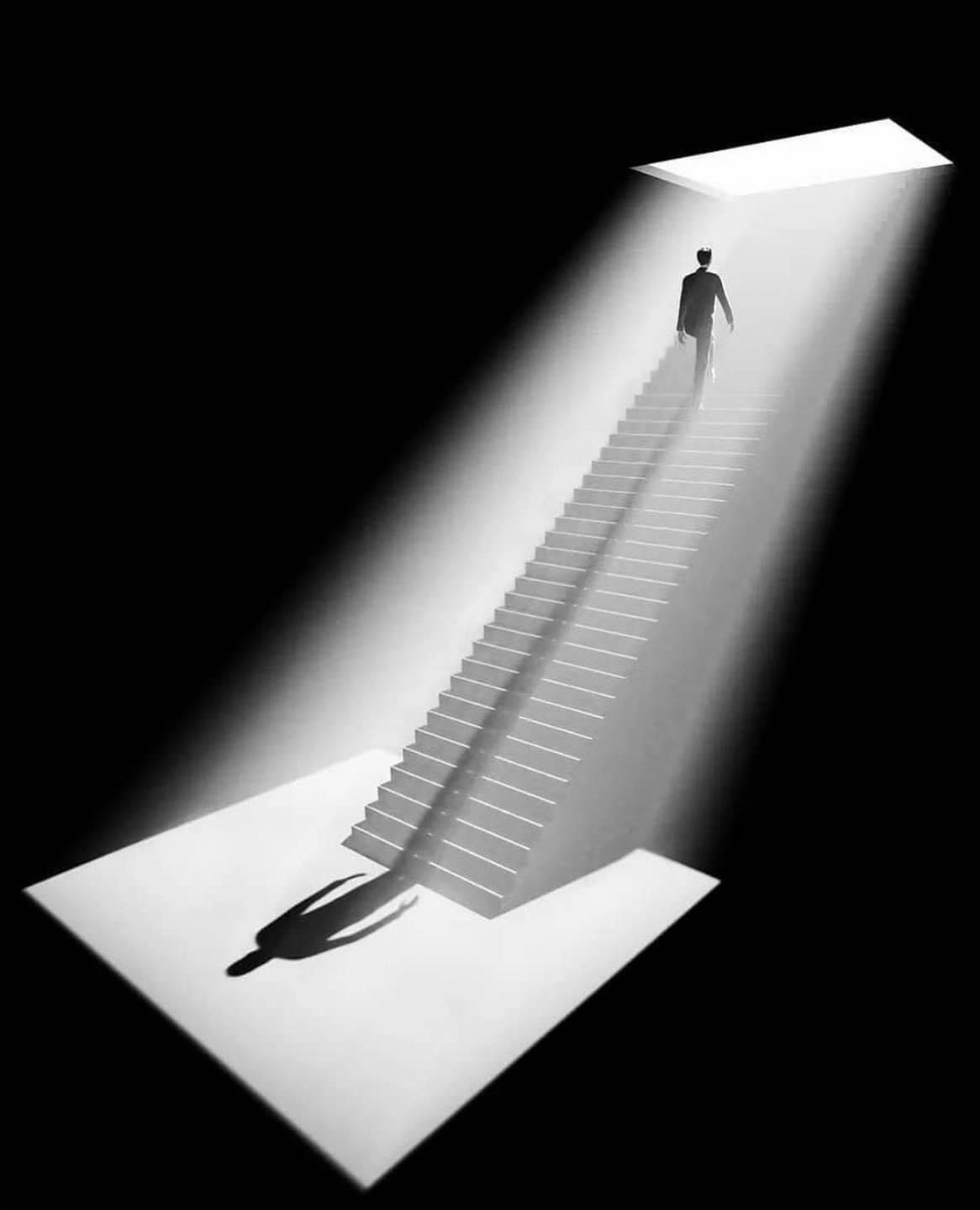 A monochrome staircase leading toward light